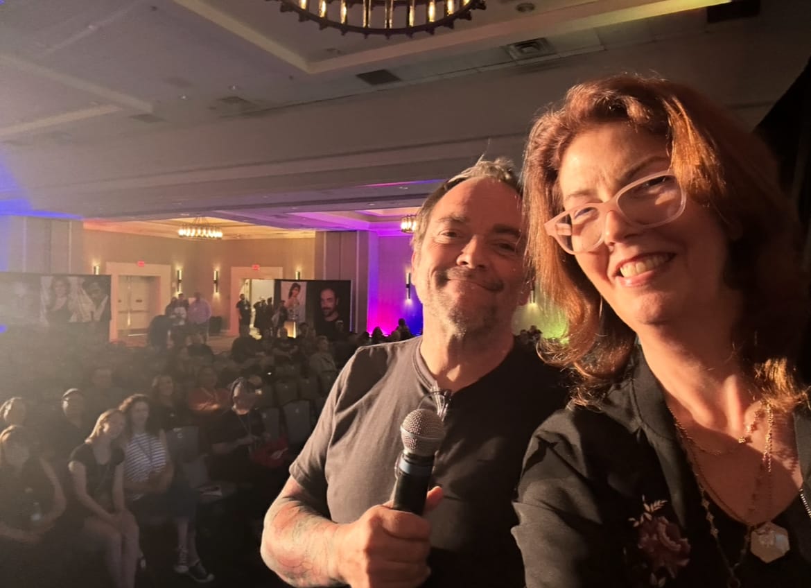 Mark Sheppard and Mo Ryan on stage with the audience behind them at the BSB 2025 convention