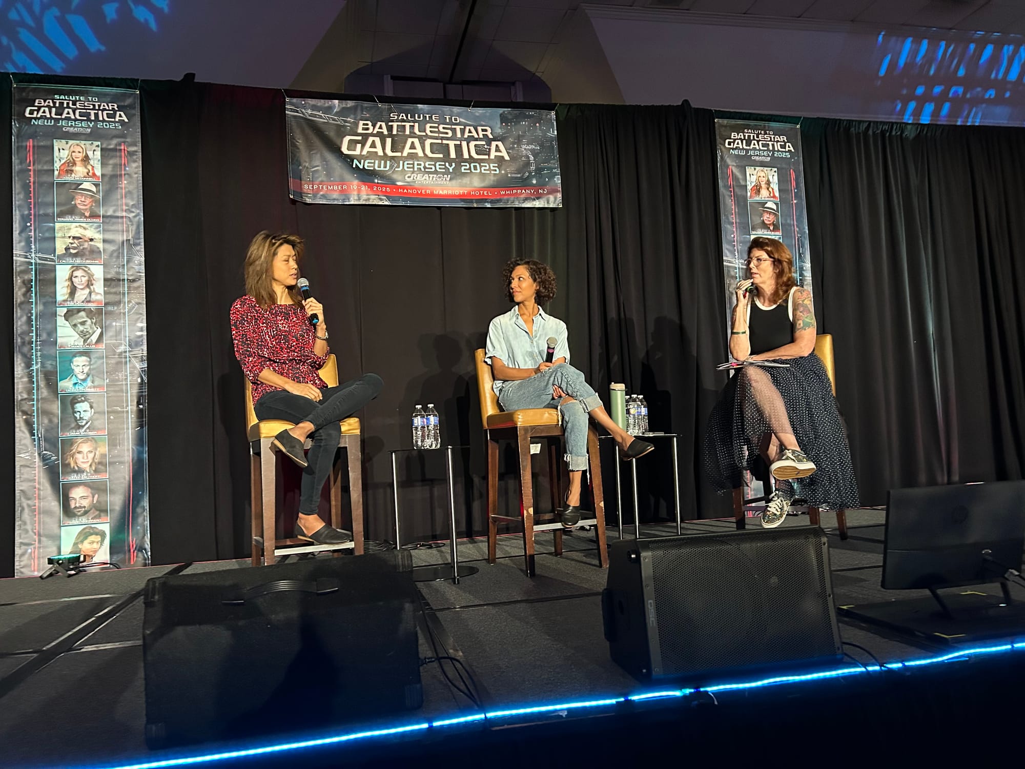 Grace Park, Rekha Sharma and Maureen Ryan are all seated on a stage at a battlestar galactica convention panel
