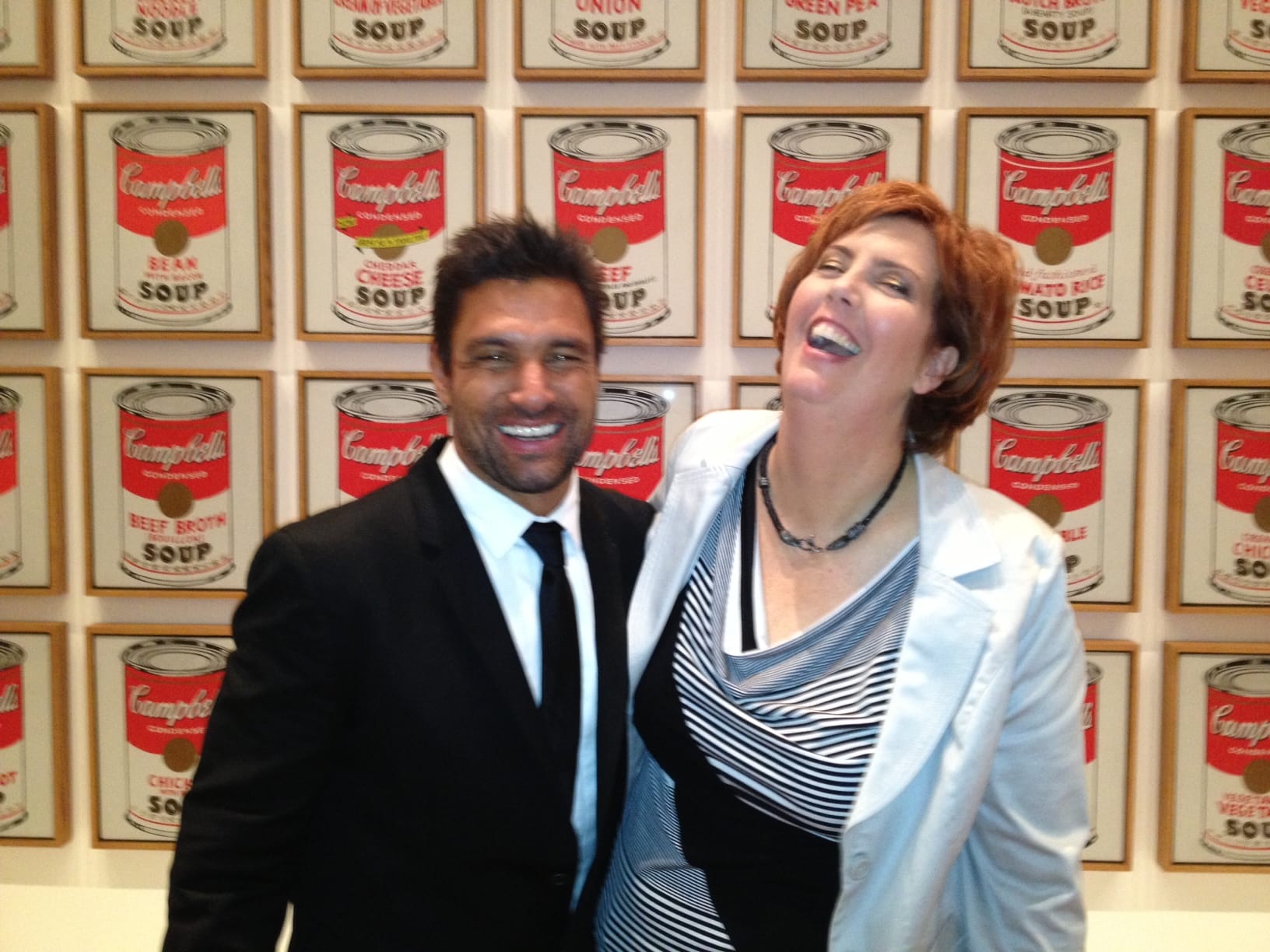 Manu Bennett and Mo Ryan, having a laugh in front of many priceless Warhol paintings